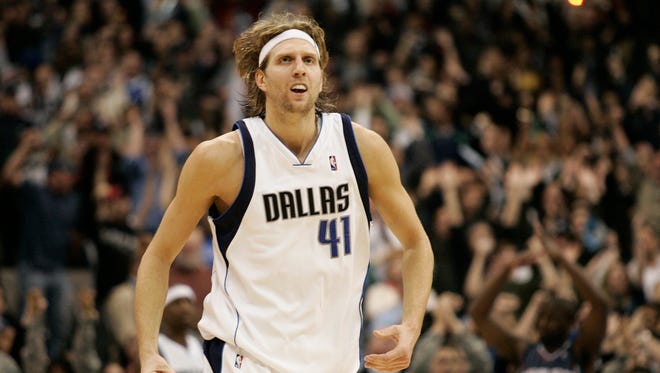 2009: Dirk Nowitzki looks up at the scoreboard after sinking the game-winning basket in overtime to defeat the Bobcats 98-97.