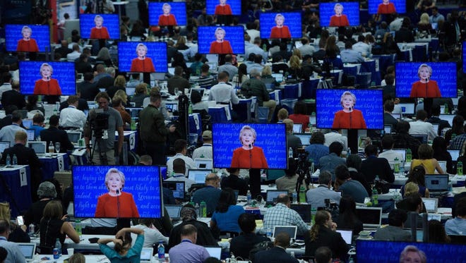 Hillary Clinton is seen on multiple screens speaking during the first U.S. presidential debate at Hofstra University, in New York on Sept. 26.