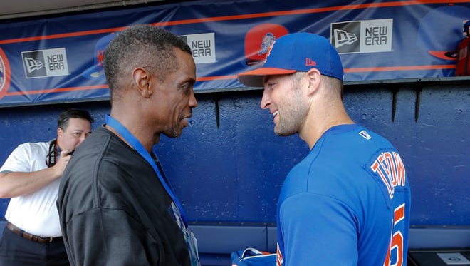 March 13: Tim Tebow, right, talks with former Mets pitcher Dwight Gooden.
