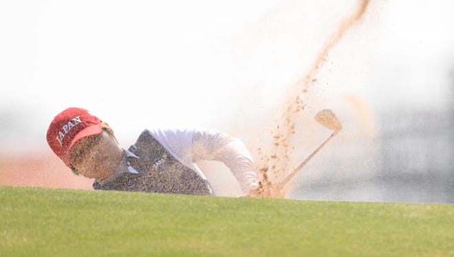 Harukyo Nomura of Japan hits from a bunker on the second hole during the third round of the women's golf tournament in the Rio 2016 Summer Olympic Games at Olympic Golf Course.