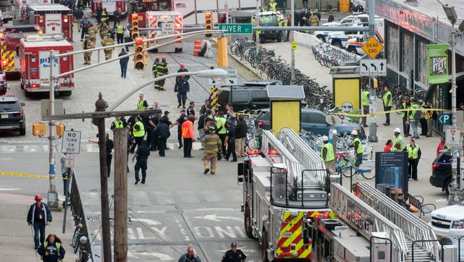 Emergency personnel work outside the rail station after a train crash in Hoboken, N.J.