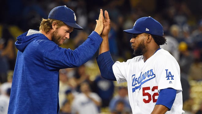 Sept. 25: Relief pitcher Pedro Baez gets a high-five from Clayton Kershaw after closing out a win against the Padres for their 100th win of the season.