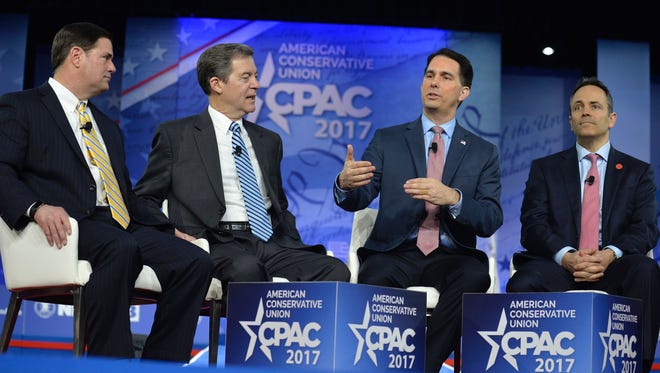 Wisconsin Governor Scott Walker (2nd R) speaks as (L-R) Arizona Governor Doug Ducey, Kansas Governor Sam Brownback and Kentucky Governor Matt Bevin listen during a panel discussion at the Conservative Political Action Conference.