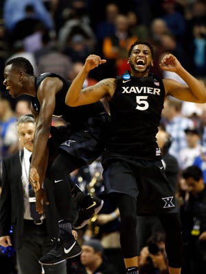Xavier Musketeers guard Malcolm Bernard (left) and guard Trevon Bluiett (5) celebrate after defeating the Arizona Wildcats during the semifinals of the West Regional of the 2017 NCAA Tournament at SAP Center.