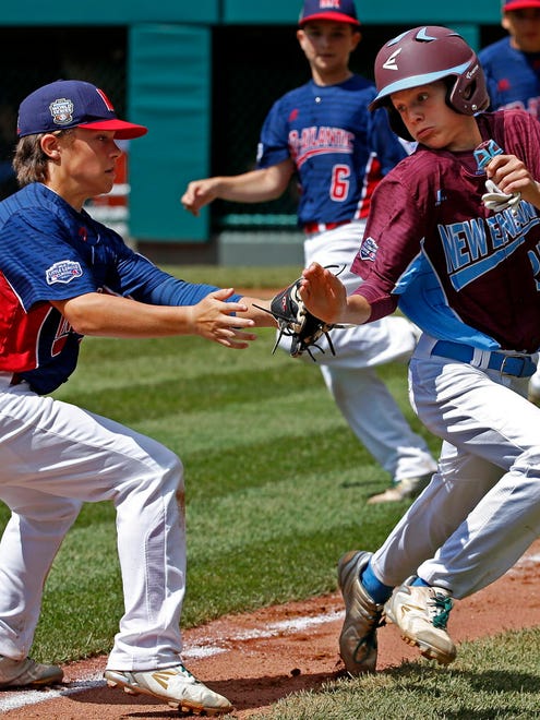 Fairfield, Conn.'s Michael Iannazzo (right) avoids the attempted tag by Jackson, N.J., shortstop Chris Cartnick to get back to third safely after being caught in a rundown between third and home in the fourth inning of an elimination game in United States pool play at the Little League World Series. Connecticut won, 12-2.