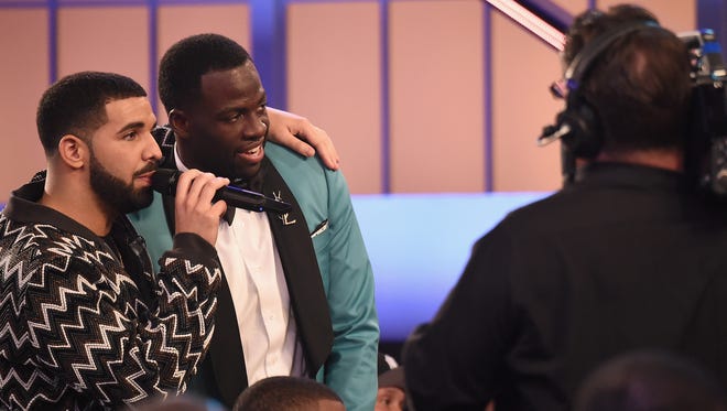 Drake and NBA player Draymond Green speak in the audience during the 2017 NBA Awards.