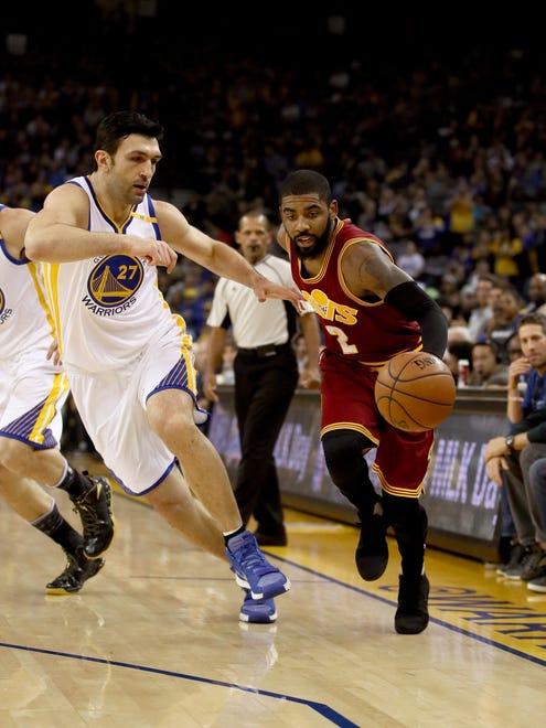 Kyrie Irving is guarded by Zaza Pachulia at Oracle Arena.
