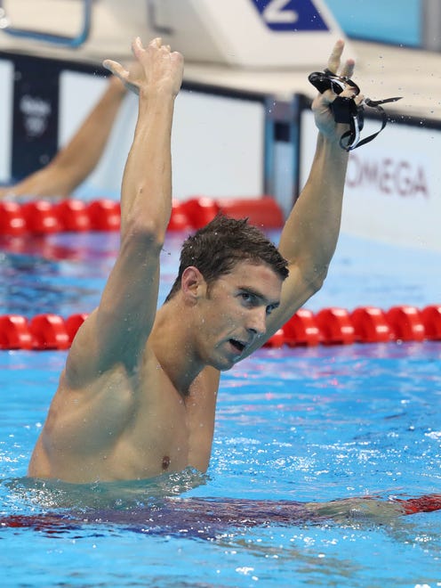 Michael Phelps celebrates after the U.S. men's 4x200m freestyle relay captured the gold medal.