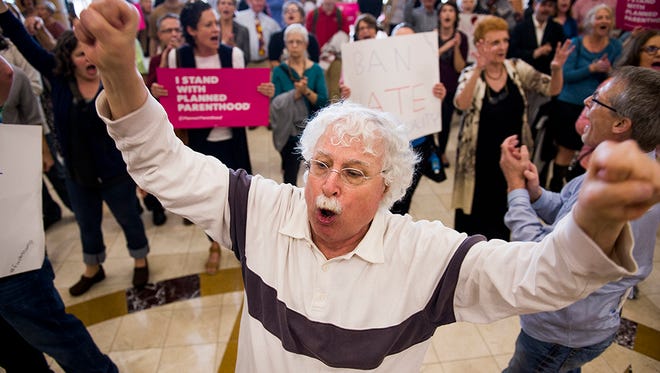 Protesters chant in the lobby of the Armstrong Center during a town hall held by Rep. Buddy Carter, R-Ga., on Feb. 21, 2017, in Savannah, Ga.