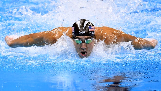Michael Phelps swims during the men's 100-meter butterfly final.