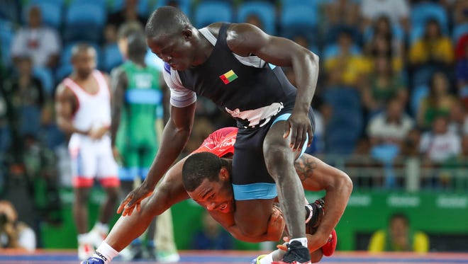 Jordan Burroughs of the United States, red, attempts a takedown of  Augusto Midana of Guinea-Bissau during men's freestyle wrestling competition in the Rio 2016 Summer Olympic Games at Carioca Arena 2. Mandatory Credit: Jason Getz-USA TODAY Sports ORG XMIT: USATSI-GRP-998 ORIG FILE ID:  20160819_sal_gb1_404.JPG