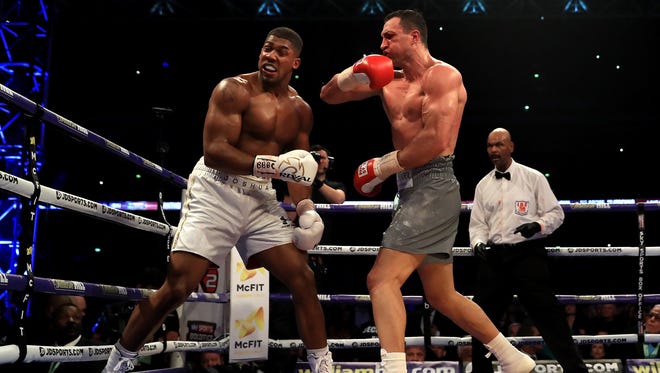 Anthony Joshua and Wladimir Klitschko in action during the IBF, WBA and IBO Heavyweight World Title bout at Wembley Stadium.