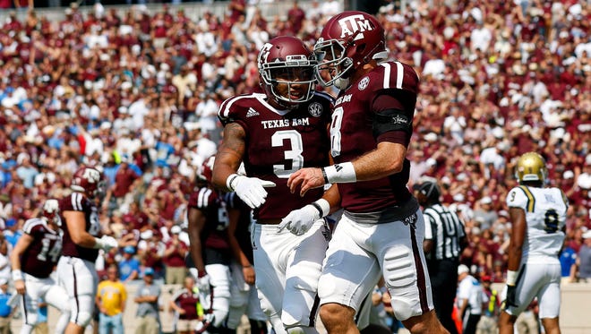Texas A&M Aggies wide receiver Christian Kirk (3) and quarterback Trevor Knight (8) celebrate the touchdown against the UCLA Bruins during the second quarter at Kyle Field.