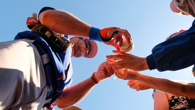 March 15: Tim Tebow signs autographs.