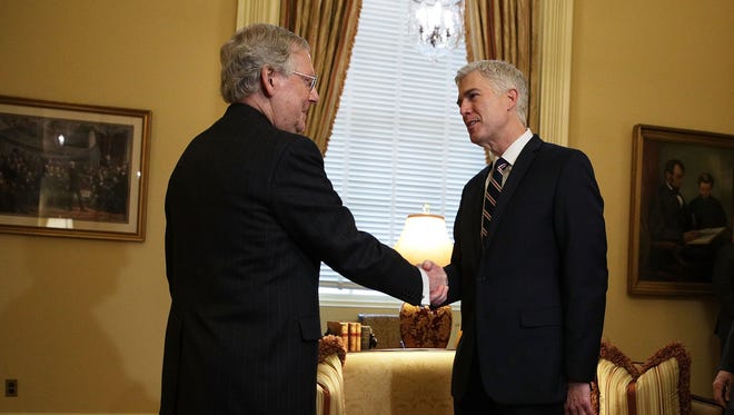 Senate Majority Leader Mitch McConnell shakes hands with Gorsuch during a meeting on Feb. 1, 2017, at the U.S. Capitol.