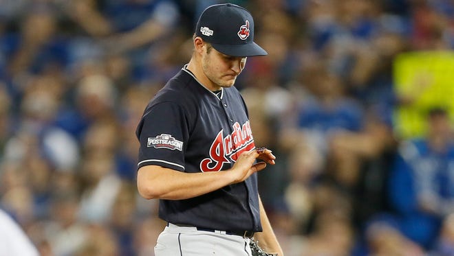 ALCS, Game 3: With blood dripping out of his injured finger, Indians starting pitcher Trevor Bauer is removed after throwing 21 pitches in the first inning. Bauer sustained a cut in his right pinkie finger while repairing one of his drones last week.
