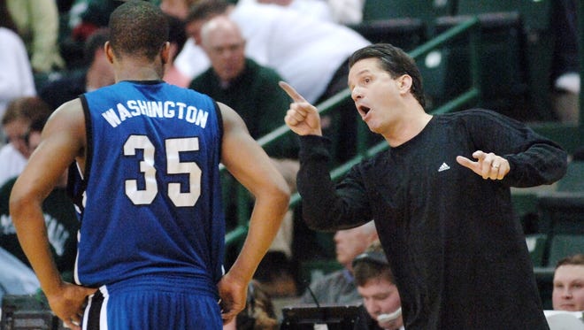 Memphis coach John Calipari, right, gives guard Darius Washington Jr. instructions during a college basketball game against Marshall on Saturday, Feb. 11, 2006, in Huntington, W.Va. Memphis won 91-81.