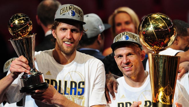 2011: Dirk Nowitzki and Jason Kidd of the Dallas Mavericks hold the MVP and Larry O'Brien Trophies after defeating the Miami Heat.