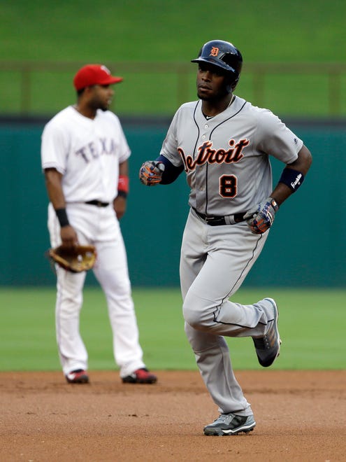 Tigers leftfielder Justin Upton (8) rounds the bases past Rangers shortstop Elvis Andrus after hitting a two-run home run in the first inning  on Monday, Aug. 14, 2017, in Arlington, Texas.
