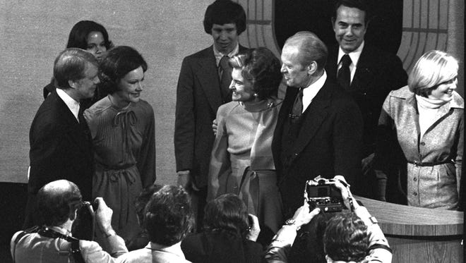 Carter and his wife, Rosalynn, talk with with Ford and first lady Betty Ford after their third and final presidential debate on Oct. 22, 1976, in Williamsburg, Va.