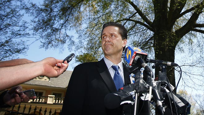 April 1, 2009 - Former Memphis basketball coach John Calipari answers question during a press conference with local media outside his East Memphis home, about leaving the university and heading to Kentucky to take over their storied program.