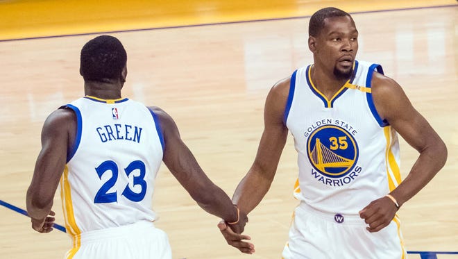 The Golden State Warriors' Kevin Durant (35) and Draymond Green enjoyed a Game 2 rout of the Spurs.