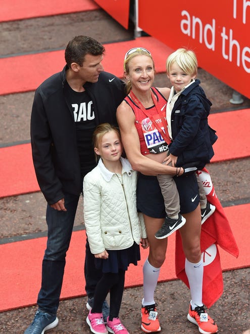 Distance runner Paula Radcliffe poses with husband, Gary Lough, and children Raphael and Isla.