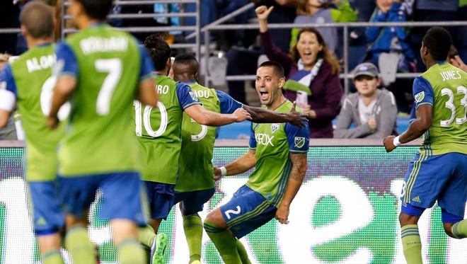 Seattle Sounders FC midfielder Clint Dempsey celebrates with teammates after scoring a penalty kick goal against the Minnesota United at CenturyLink Field.