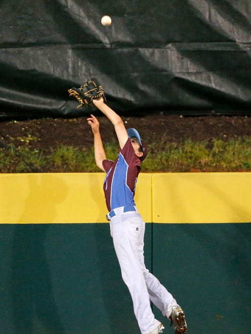 Fairfield, Conn., center fielder Landon Welter leaps to rob Walla Walla, Wash.'s Hayden Lomeli of a home run in the fifth inning of an elimination baseball game in United States pool play at the Little League World Series tournament in South Williamsport, Pa.