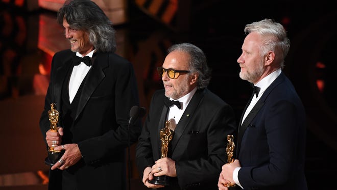 Giorgio Gregorini, left, Alessandro Bertolazzi  and Christopher Nelson, right, accept the award for Achievement in makeup and hairstyling for 'Suicide Squad' during the 89th Academy Awards.