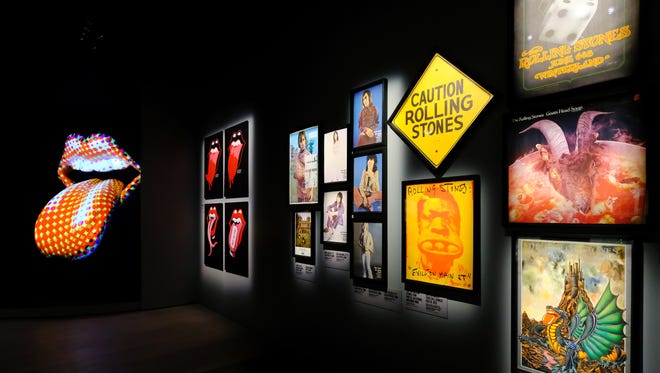 Tour posters and album art is on display, along with the Stones' iconic logo.