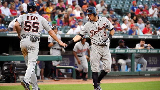 Tigers second baseman Ian Kinsler (3) congratulates catcher John Hicks (55) after Hicks scored on a double by Jose Iglesias in the second inning on Tuesday, Aug. 15, 2017, in Arlington, Texas.