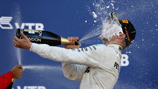 Valtteri Bottas of Finland celebrates on the podium after winning the Formula One Grand Prix of Russia.