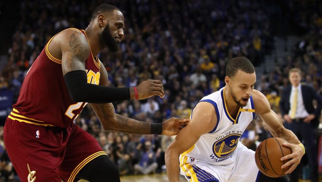 Stephen Curry steals the ball from LeBron James.
