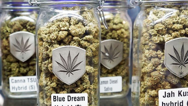 Jars of medical marijuana sit on a shelf inside a Denver-based marijuana dispensary. Blue Dream is known for giving users a euphoric high.