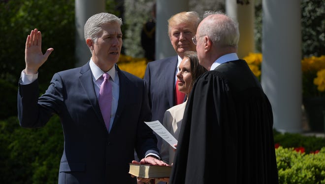 President Trump watches as Justice Anthony Kennedy administers the oath of office to Neil Gorsuch as an associate justice of the Supreme Court in the Rose Garden of the White House on April 10, 2017.