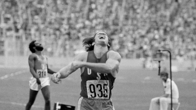 Jenner of San Jose, Calif., expresses the exertion necessary to win the decathlon 400 meter heat, on July 29, 1976 in the Montreal, Olympics. In back is France's Gilles Gemise-Fareau.