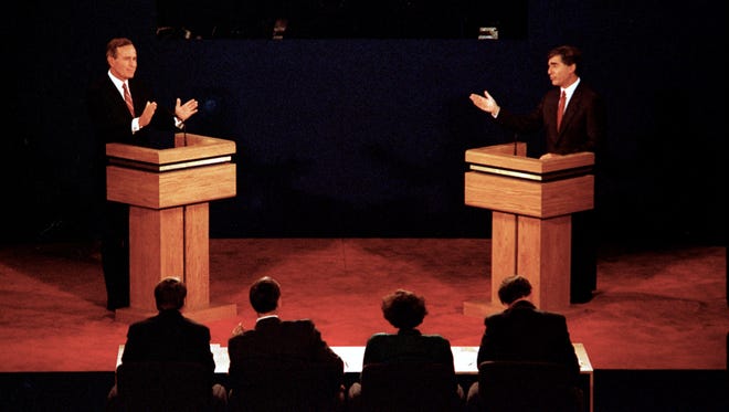 George H.W. Bush and Michael Dukakis gesture during their first presidential debate at Wake Forest University in Winston-Salem, N.C., on Sept. 25, 1988.