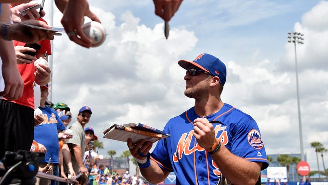 March 13: Tim Tebow signs autographs before the game against the Marlins.