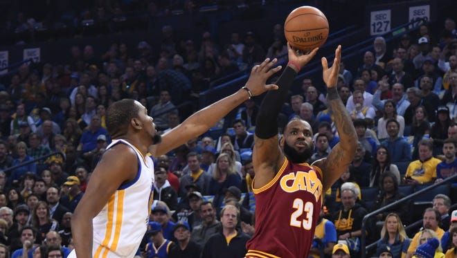 Cleveland Cavaliers forward LeBron James (23) shoots the basketball against Golden State Warriors forward Kevin Durant (35) during the first quarter at Oracle Arena.