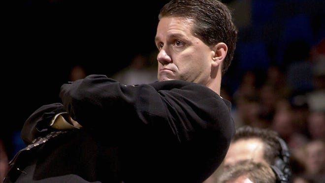 November 8, 2000 - University of Memphis head coach John Calipari(cq) reclines on the press table as he keeps an eye on the game action Wednesday evening at the Pyramid.