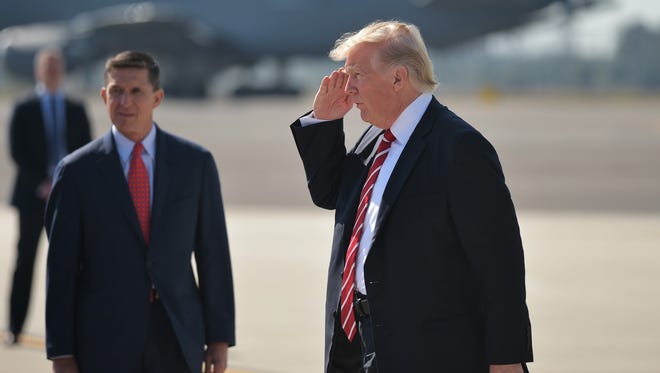 This file photo taken Feb. 6 shows National Security Adviser Michael Flynn and President Trump upon arrival at MacDill Air Force Base in Tampa.