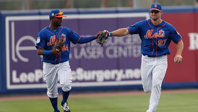 March 13: Curtis Granderson and Tim Tebow run off the field following a Tebow catch against the Marlins.