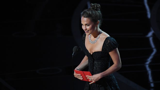 Alicia Vikander presents the award for best supporting actor during the 89th Academy Awards.