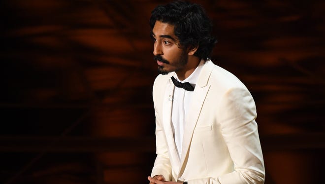 Dev Patel introduces Sting as he performs the Oscar nominated song 'The Empty Chair' from 'Jim: The James Foley Story' during the 89th Academy Awards.
