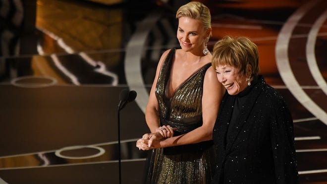 Charlize Theron, left, and Shirley MacLaine present the award for best foreign film during the 89th Academy Awards.