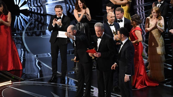 Jordan Horowitz, a producer for " La La Land, " holds up the card showing " Moonlight " as the real best picture winner.