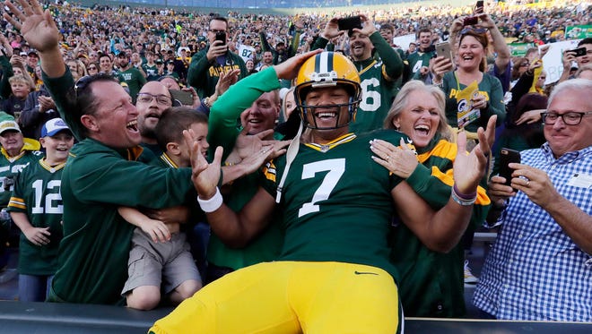 Green Bay Packers quarterback Brett Hundley (7) takes a Lambeau Leap after rushing for a touchdown against the Los Angeles Rams at Lambeau Field.