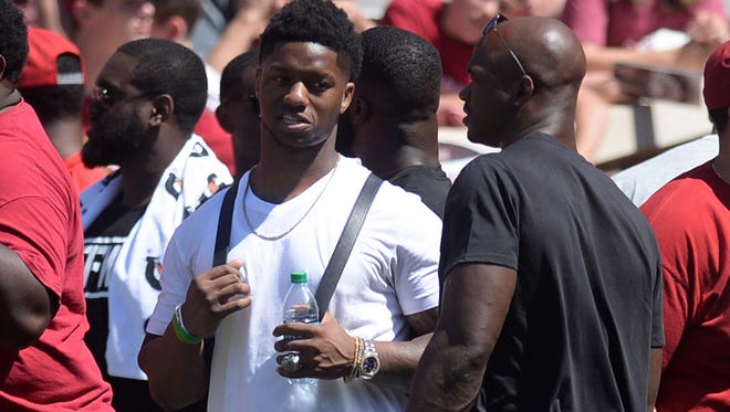 Former Oklahoma players Joe Mixon and Adrian Peterson talk during the school's spring game.