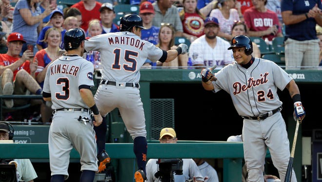 Tigers second baseman Ian Kinsler (3) watches as centerfielder Mikie Mahtook (15) leaps near the dugout near designated hitter Miguel Cabrera (24) after Mahtook's home run that scored Kinsler during the third inning on Wednesday, Aug. 16, 2017, in Arlington, Texas.